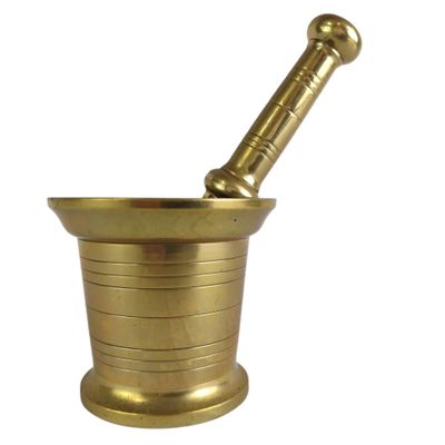 a brass mortar with a pestula in it on a white background
