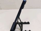 a black tablet computer on a stand on a white surface
