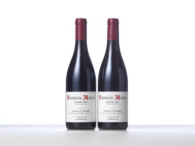 two bottles of wine sitting on top of a white counter