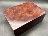 an image of a wooden box on a table with a black background