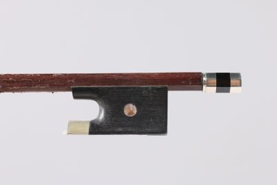 a close up of a violin bow on a white surface