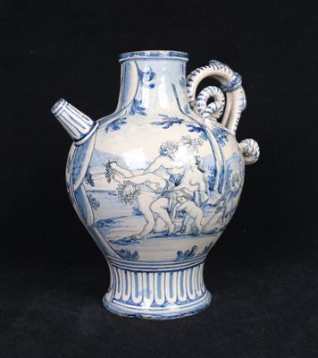a blue and white vase with a handle on a black background