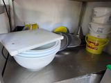 a white bowl sitting on top of a metal counter