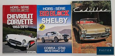 three books on display on the wall of a car showroom