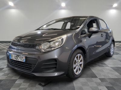 the grey car is parked on a checkered floor in the garage