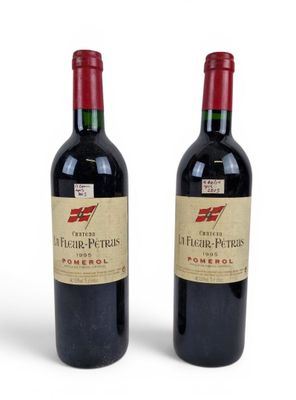 two bottles of red wine sitting next to each other on a white surface