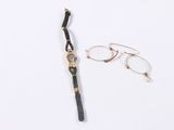 pair of glasses and a watch laying on a white surface