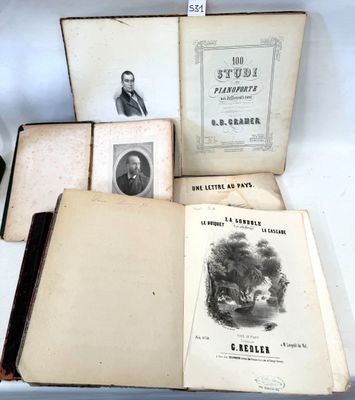 several old books sitting on top of a white table next to a cup of coffee