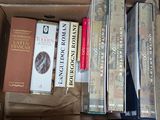 many books in a box on a table