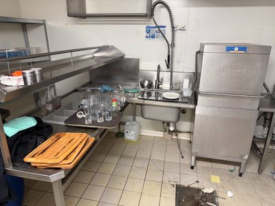 a kitchen with a sink and a refrigerator in it