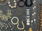 several different types of necklaces and bracelets on a table