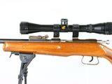 a close up of a rifle with a scope on a white background