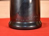 an image of a silver vase on a red cloth