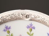 a close up of a plate with purple flowers on it