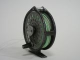 an image of a reel with a spool on a white surface