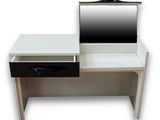 a desk with a mirror and a laptop on it
