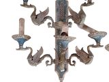 a wall mounted sconce with a bird design on it