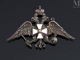 a close up of a metal badge with a cross on it