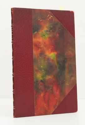 a close up of a book with a red cover on a white surface