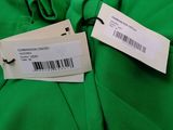 a label on a green dress with a price tag attached to it