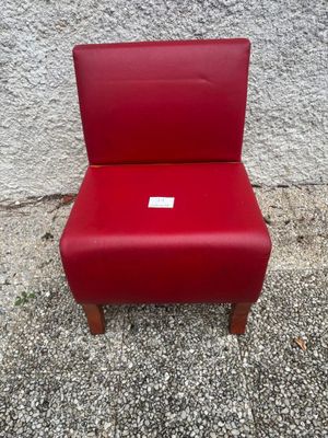 a red chair that has a tag on it