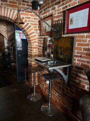 two stools in front of a table with a laptop on it