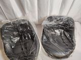 two pairs of shoes that are wrapped in plastic