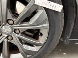 a close up of a car wheel with a sticker on it