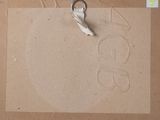 a pair of scissors sitting on top of a piece of cardboard