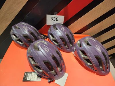 three purple helmets on a table with a price tag on it