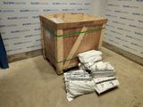 a wooden box with a bunch of bags on top of it