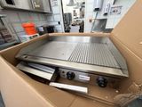 a box with a grill inside of it in a kitchen