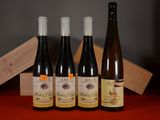 three bottles of wine sit on a table next to a wooden box