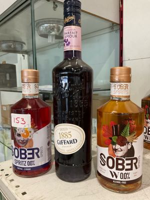 several bottles of alcohol are lined up on a counter