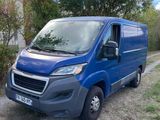 the blue van is parked on the side of the road