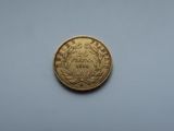 a close up of a gold coin on a white surface