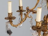 a gold chandelier with three candles on it
