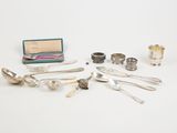 several silverware items including spoons, cups, and a box