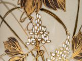 an image of a close up of a vase with gold leaves on it