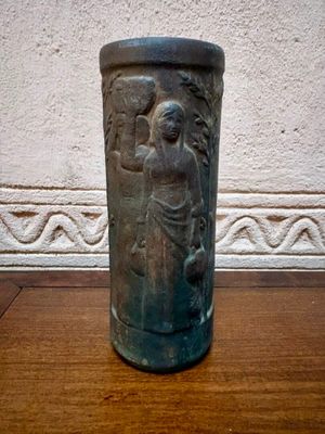 un vase posé sur une table devant un mur