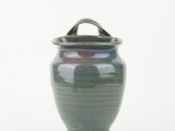 a blue vase with a handle on a white background