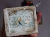 someone is holding a small box with a picture of a man on it