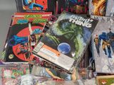 a pile of comic books sitting on a table