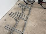 a bike that is parked next to a bike rack