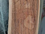 a close up of a skateboard with a wooden board on it ' s back