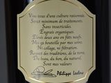 a bottle of wine with a gold label on it