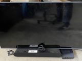 a black flat screen tv sitting on top of a table