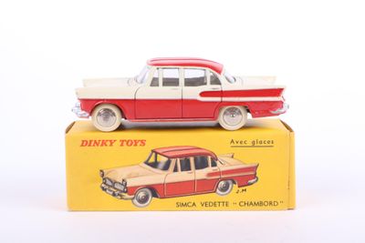 a red and white toy car sitting on top of a yellow box