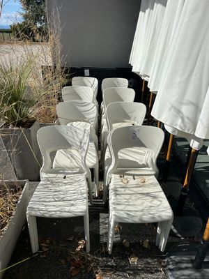 many chairs and umbrellas lined up in a row