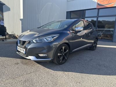 une Nissan Murano grise garée devant un immeuble